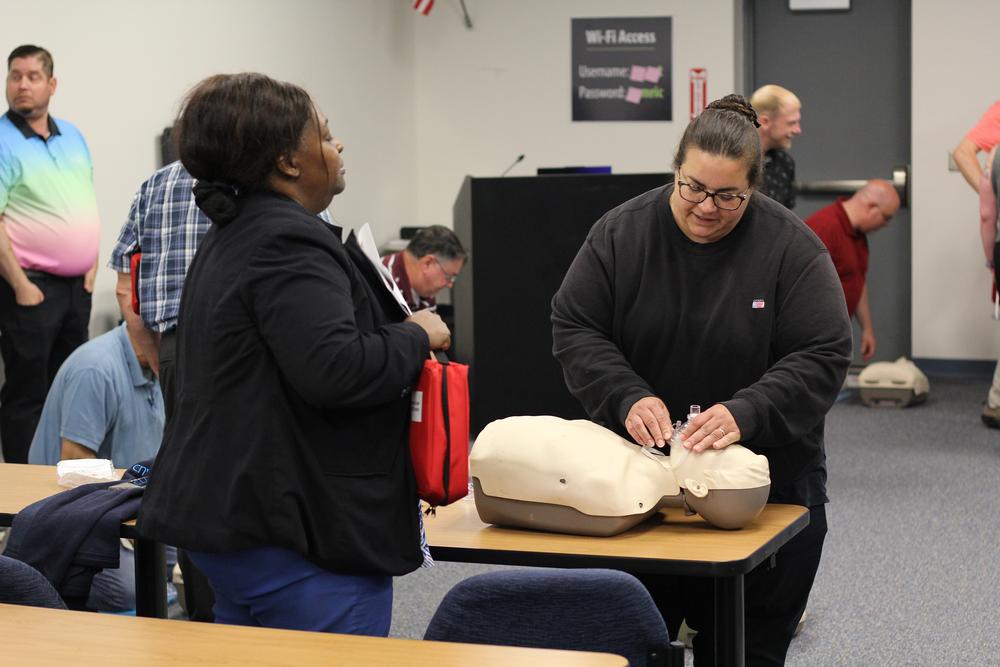 cnyric trainee practices affixing face mask to training mannequin