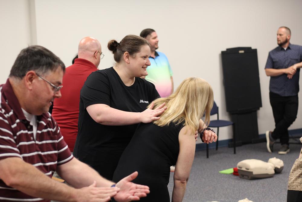 trainees pair up to practice "back pat" in effort to dislodge trapped food