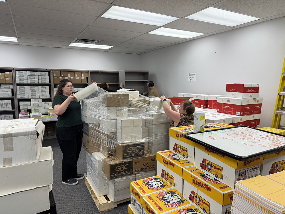 print shop's binding room being cleaned  up, supplies packaged and reorganized