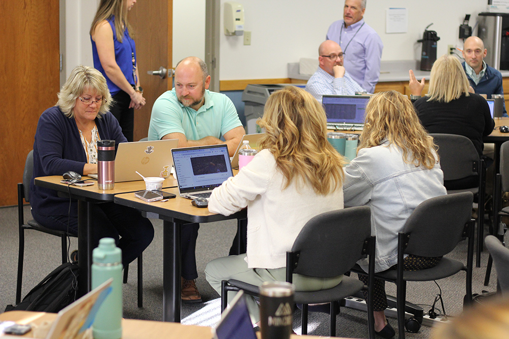 team members prepare their laptops for the day ahead