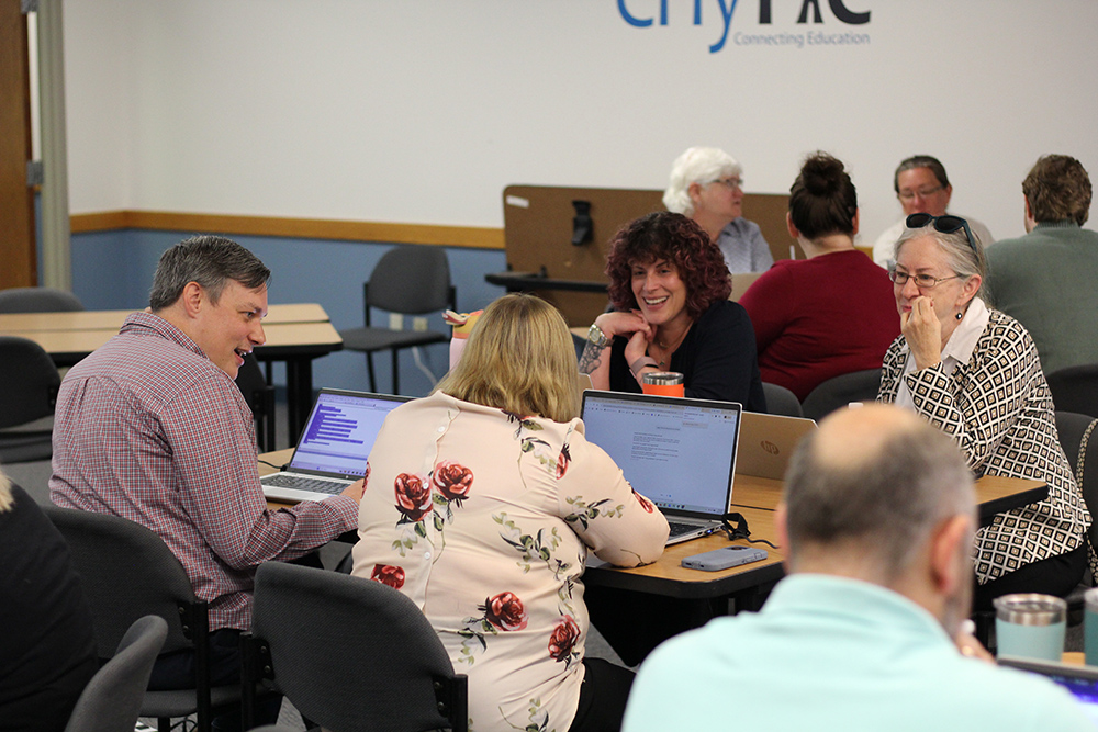 team members work collaboratively on icebreaker exercise early in the day